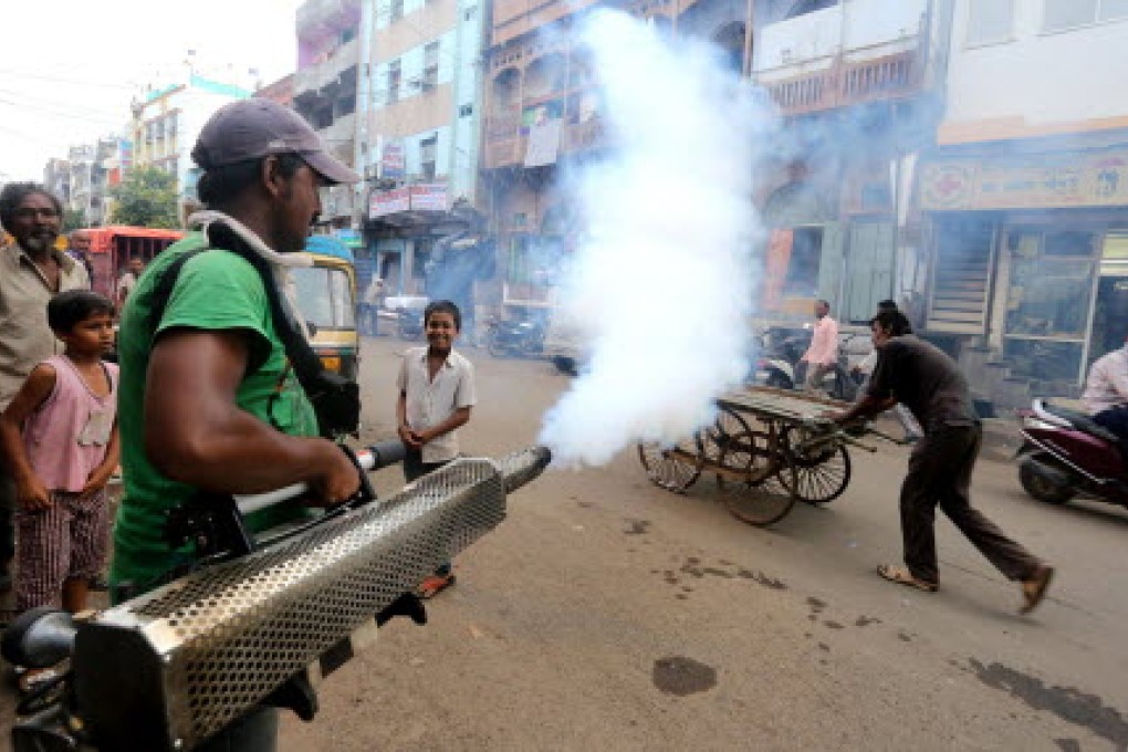 A sanitation worker fumigates a neighbourhood in Bhopal, India, where dengue fever has also been a major concern in the past few weeks. Photo: Xinhua