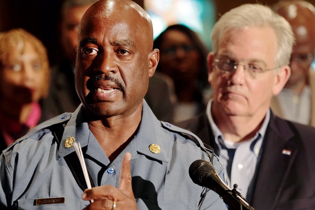 Missouri Gov. Jay Nixon listens as Missouri Highway Patrol Capt. Ron Johnson (left) answers questions at a news conference in Ferguson. Photo: AP