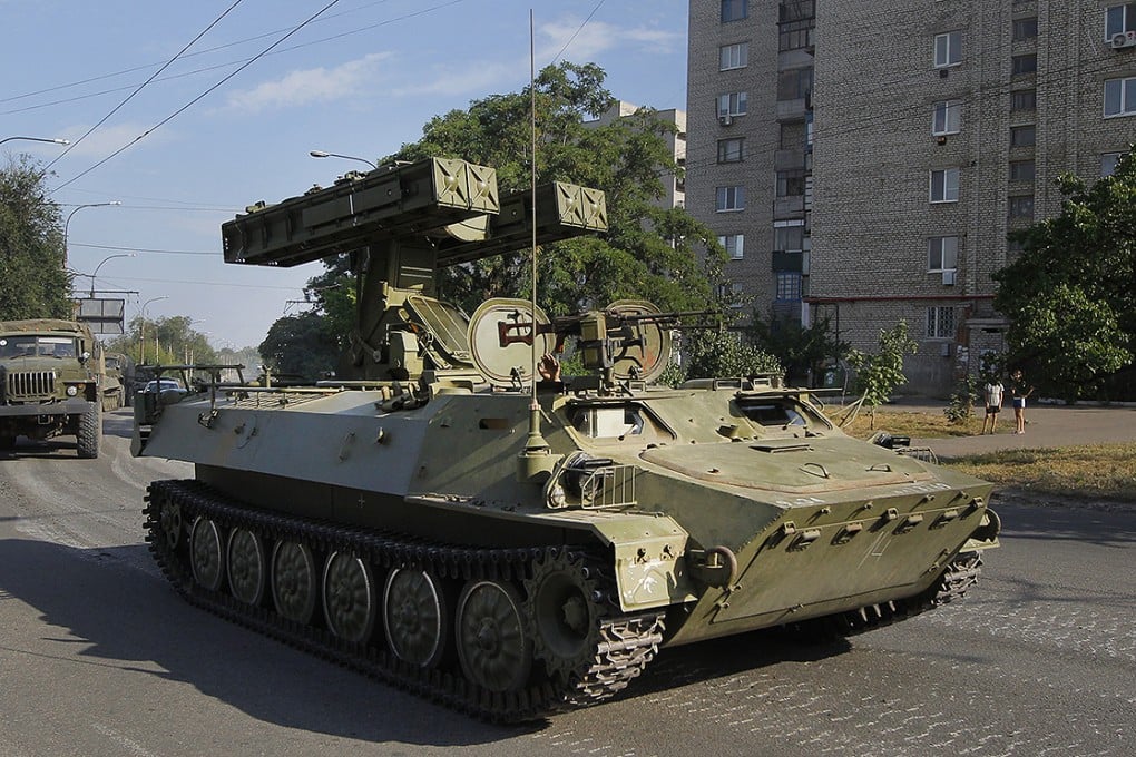 A missile launcher used by pro-Russian rebel forces drives through the town of Krasnodon, eastern Ukraine, on Sunday. Photo: AP