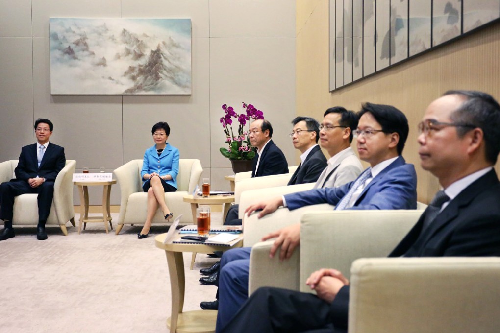 (From left) liaison office chief Zhang Xiaoming and host Chief Secretary Carrie Lam Cheng Yuet-ngor at the meeting in the government's Tamar offices yesterday with lawmakers Frederick Fung, Dr Joseph Lee Kok-long, Ip Kin-yuen and Charles Mok, and Undersecretary for Constitutional and Mainland Affairs Lau Kong-wah. Photo: Nora Tam