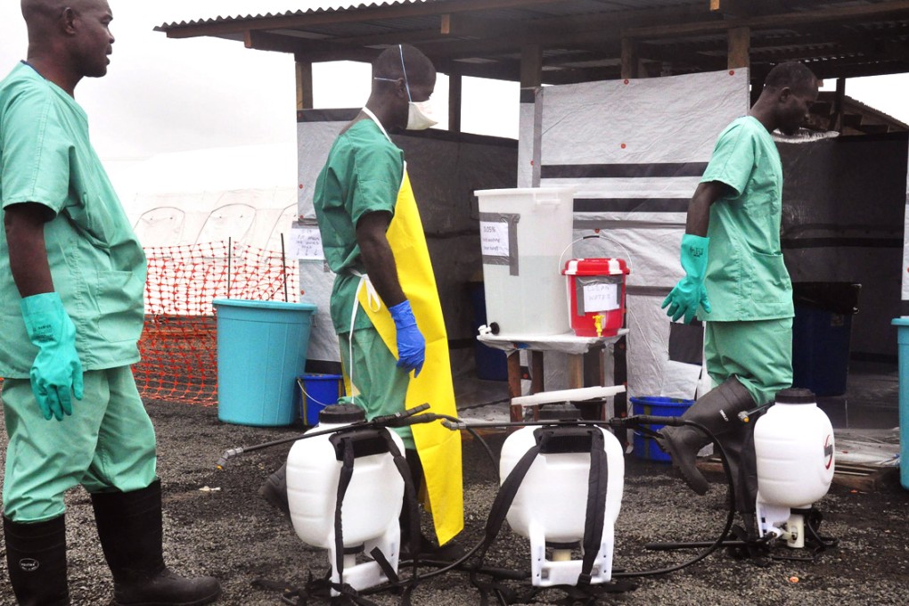 Health workers prepare disinfectant in containers. Photo: AP