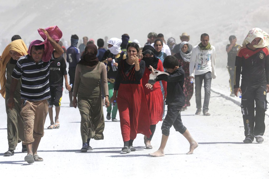Refugees take part in a demonstration at the Iraqi-Turkish border in the semi-autonomous Kurdish region in northern Iraq. Photo: Reuters
