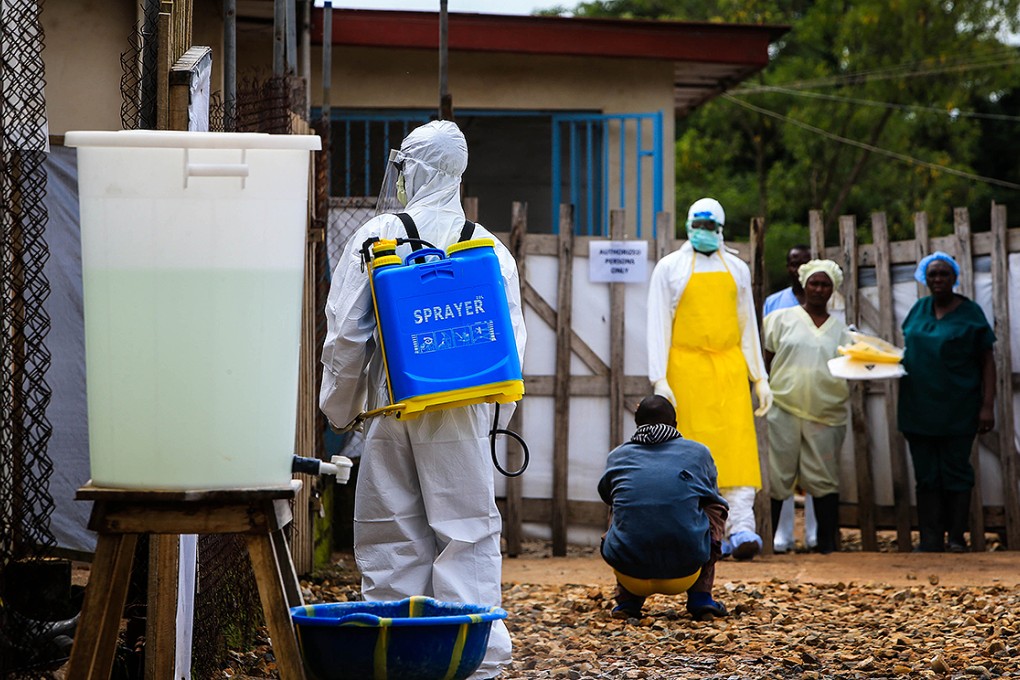 A medical worker is seen outside an Ebola treatment centre at the government hospital in Kenema, eastern Sierra Leone. Photo: Xinhua