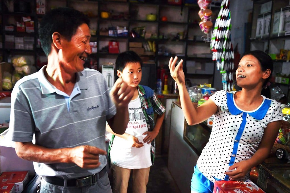 Vietnamese bride Vu Thi Hong Thuy, 21, chats with customers at the shop where she works in Weijian village in Henan. Photo: AFP