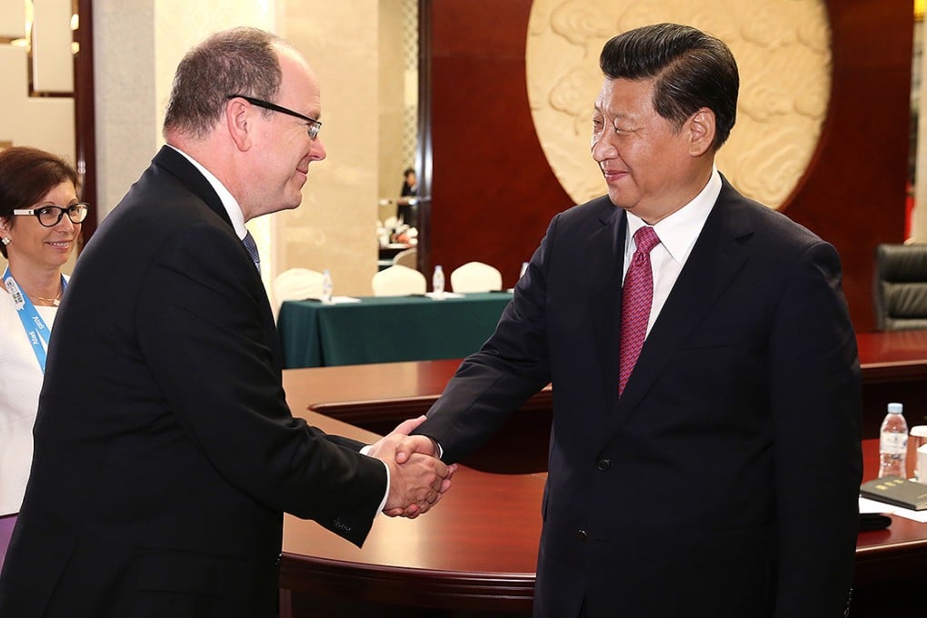 Xi Jinping shakes hands with Prince Albert II of Monaco in Nanjing. Photo: Xinhua