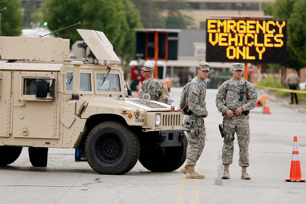 National Guard troops are deployed to provide protection for a police command centre in Ferguson. Photo: AFP