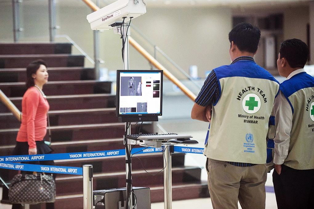 Myanmar health officials screen passengers arriving at Yangon international airport. A local man is still undergoing tests for Ebola after arriving from Guinea with a fever. Photo: AFP