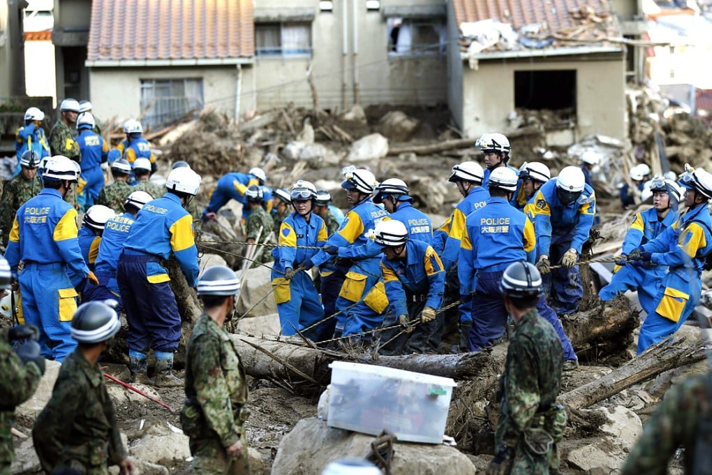 Japan Self-Defense Force soldiers and police officers search for survivors at the site where a landslide swept through a residential area at Asaminami ward in Hiroshima. Photo: Reuters