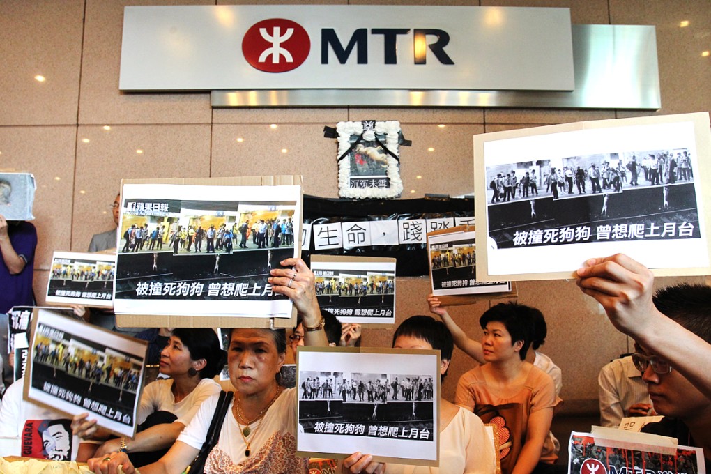 Protesters outside MTR headquarters held aloft images of the stray dog trying to get back onto the platform. Photo: May Tse