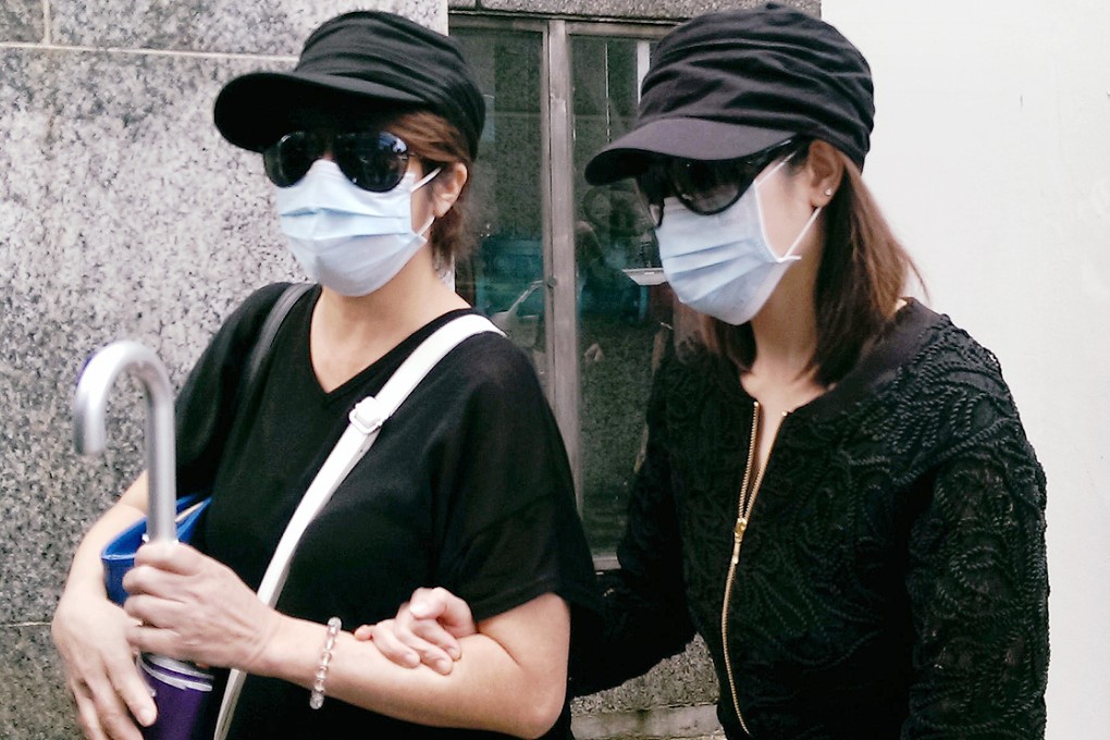 Law Wan-tung, right, arrives with a similarly dressed lookalike ahead of her District Court hearing yesterday. Photo: Chris Lau