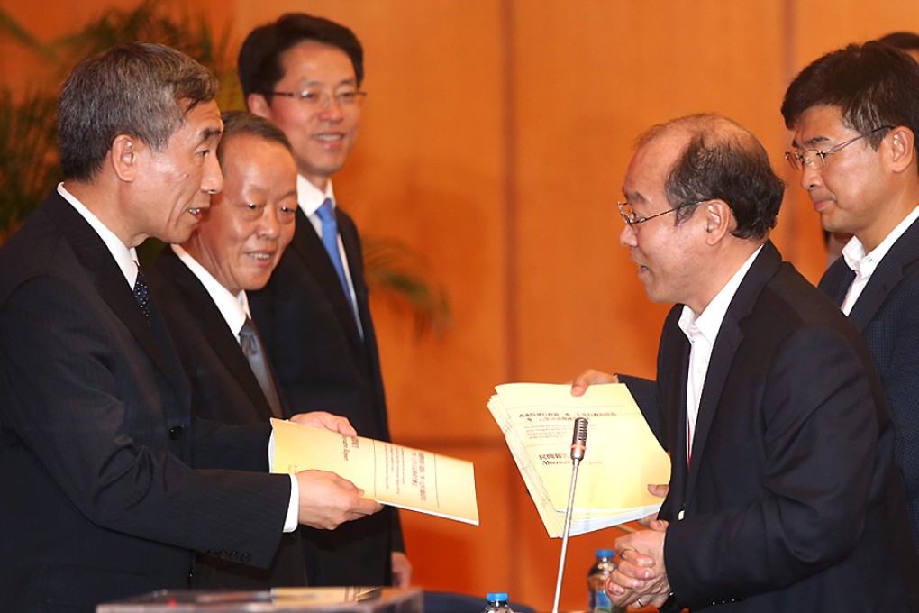 Li Fei, Wang Guangya and Zhang Xiaoming receive a report from pan-democrats Frederick Fung Kin-kee and Sin Chung-kai. Photo: K.Y. Cheng