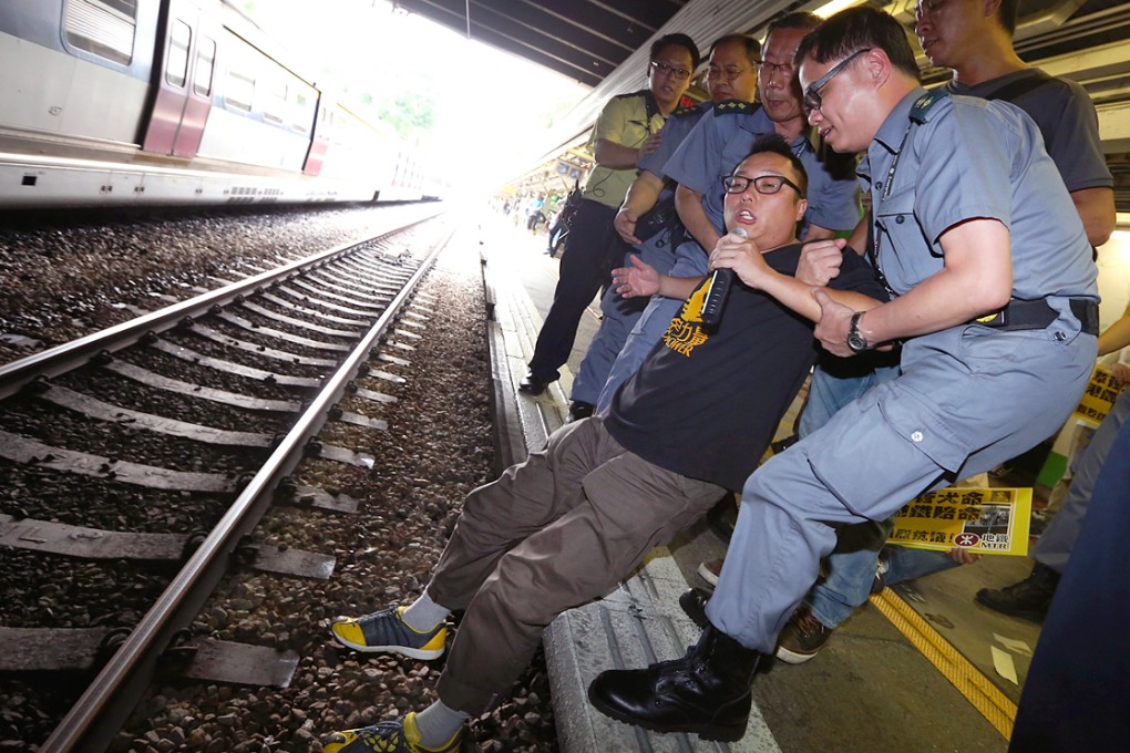 People Power activist Tam Tak-chi takes part in a protest at Fanling station. Photo: Sam Tsang