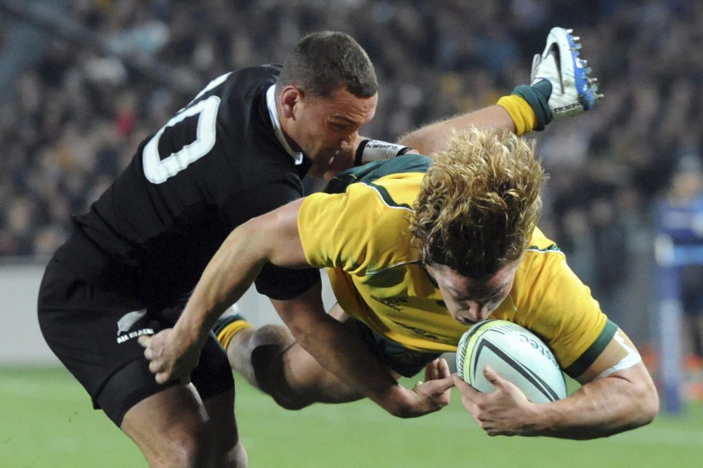 All Black Aaron Cruden dumps Wallaby Michael Hooper in a tackle during their Bledisloe Cup match at Eden Park in Auckland. New Zealand were just too clinical in their convincing 51-20 win. Photo: AP