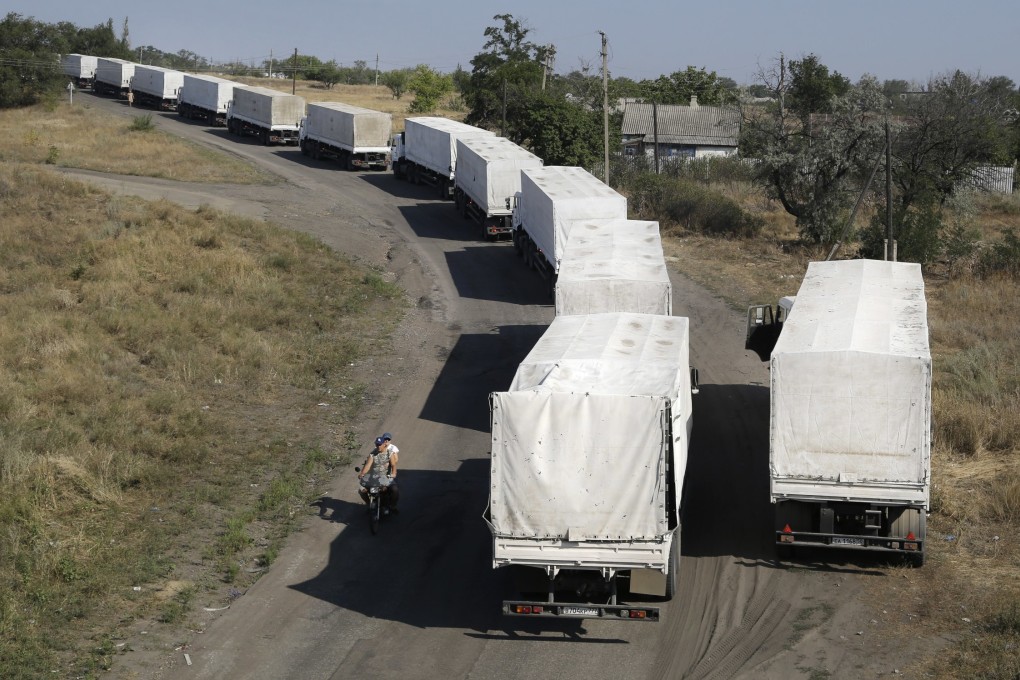 Trucks marked as being part of a Russian aid convoy wait in line at the border post at Izvaryne in eastern Ukraine. Photo: AP