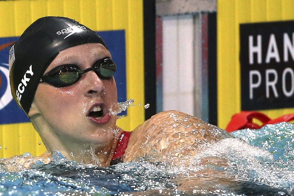 Katie Ledecky looks at the scoreboard as she breaks the world record in the women's 400m freestyle at the Pan Pacific championships. Photo: AP