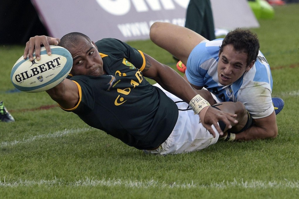 South Africa wing Cornal Hendricks scores a try while being tackled by Argentina fullback Joaquin Tuculet. Photo: AFP