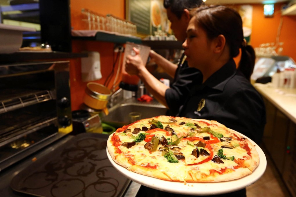 Having a pizza in Tripoli.Photo: AFP