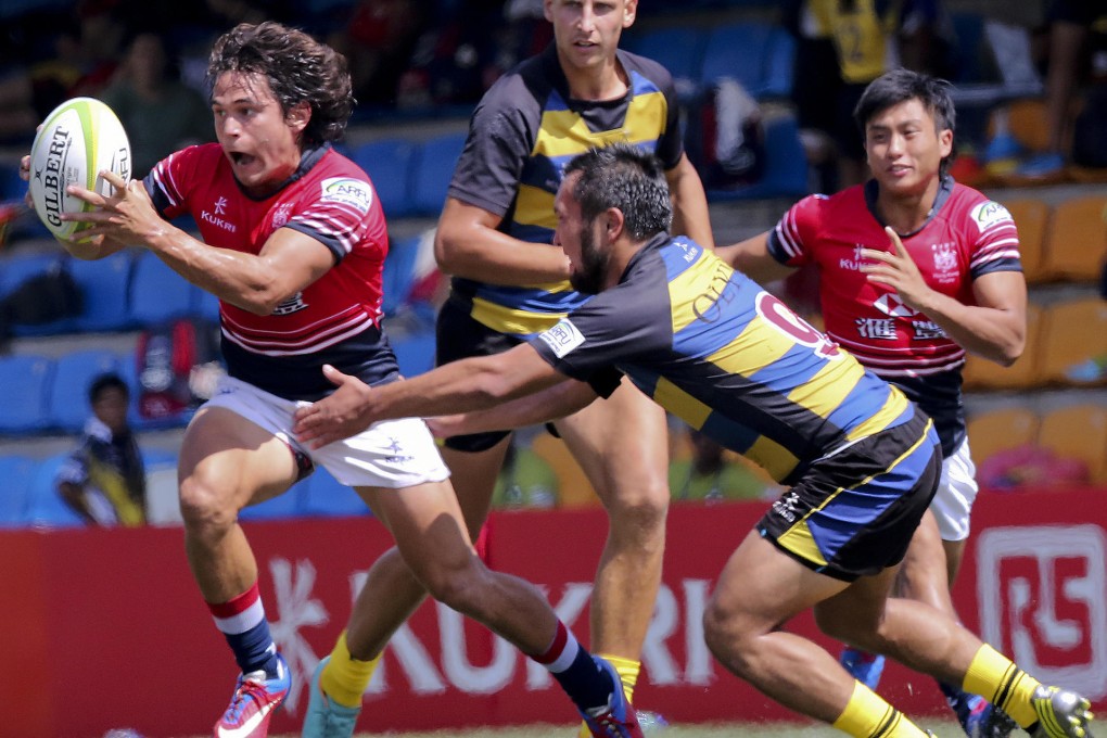 Rowan Varty eludes a Kazakhstan player during Hong Kong's 38-5 victory at HKFC on Saturday. Hong Kong also beat the Philippines 24-0. Photos: Felix Wong