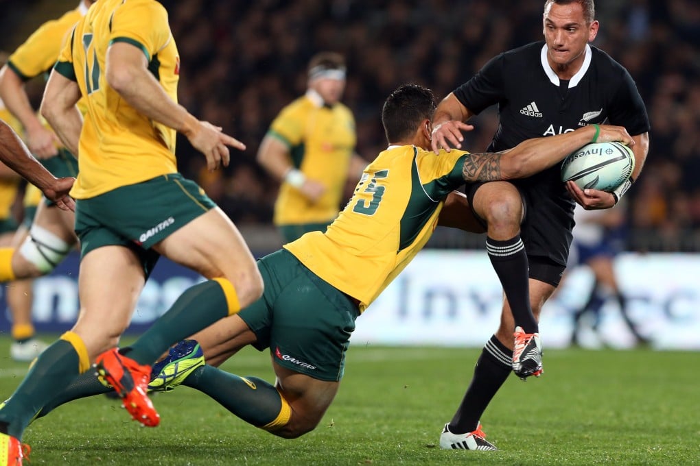 New Zealand All Blacks fly-half Aaron Cruden is tackled by Australia’s Israel Folau during their test match at Eden Park. Photo: AFP