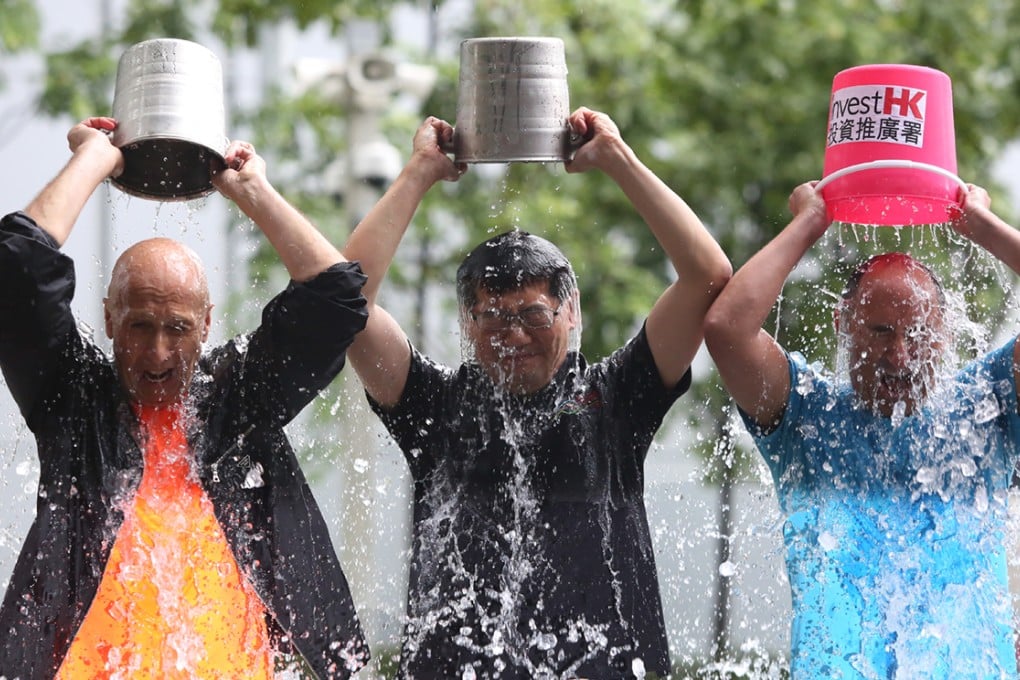 Commerce chief Gregory So Kam-leung (centre) takes part in the Ice Bucket Challenge. Photo: Sam Tsang