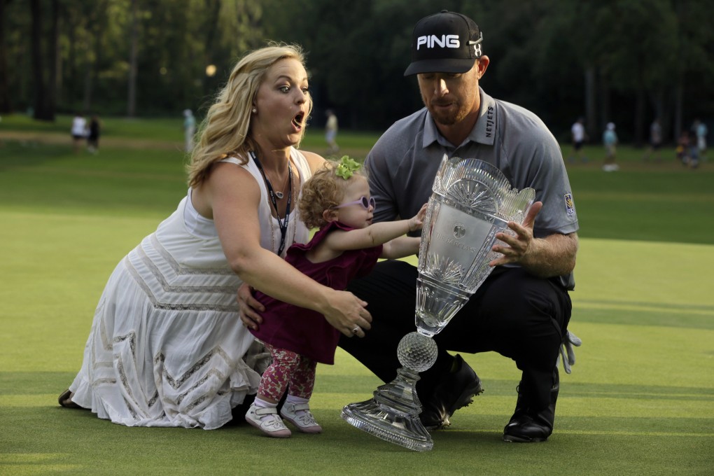 Hunter Mahan celebrates his victory with wife Kandi and daughter Zoe. Photo: AFP