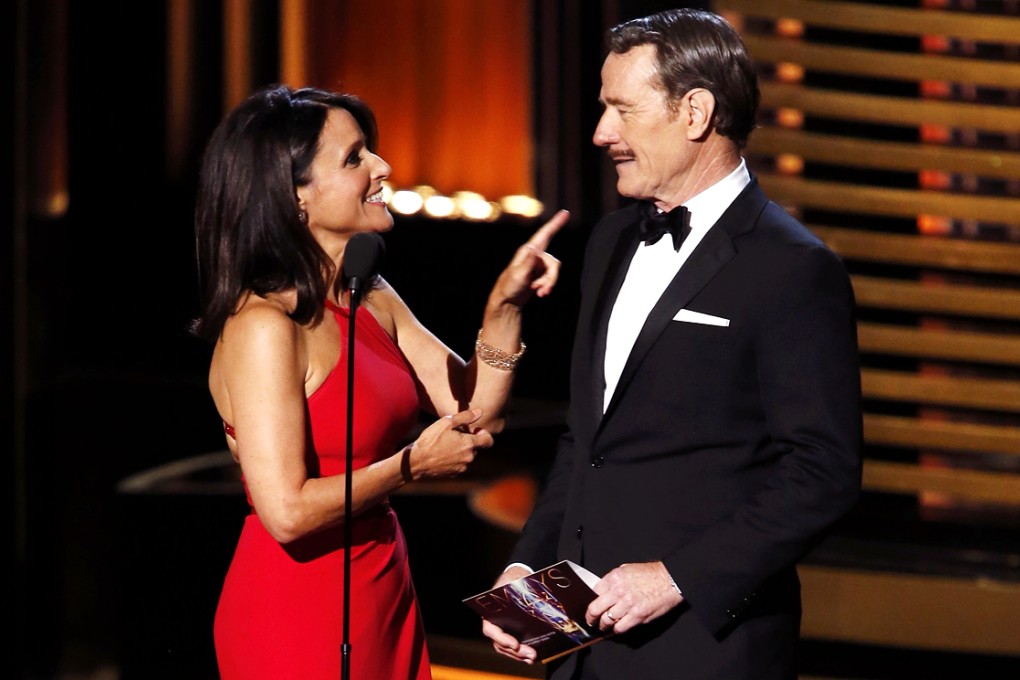Presenters Julia Louis Drefuss and Bryan Cranston talk before presenting the award for Outstanding Lead Actor In A Comedy Series onstage during the 66th Primetime Emmy Awards in Los Angeles on August 25, 2014. Photo: Reuters