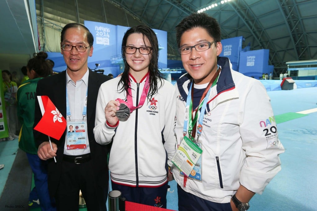 Secretary for Home Affairs Tsang Tak-sing and Kenneth Fok flank  Siobhan Haughey after she won the silver medal in the 200m individual medley at the Nanjing Youth Olympics. Photo: SCMP Pictures