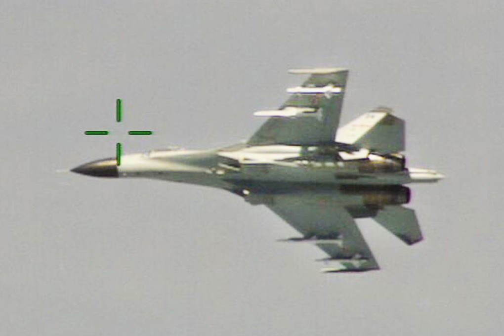 A Chinese J-11 fighter jet is seen flying near a US Navy P-8 Poseidon east of China's Hainan Island.