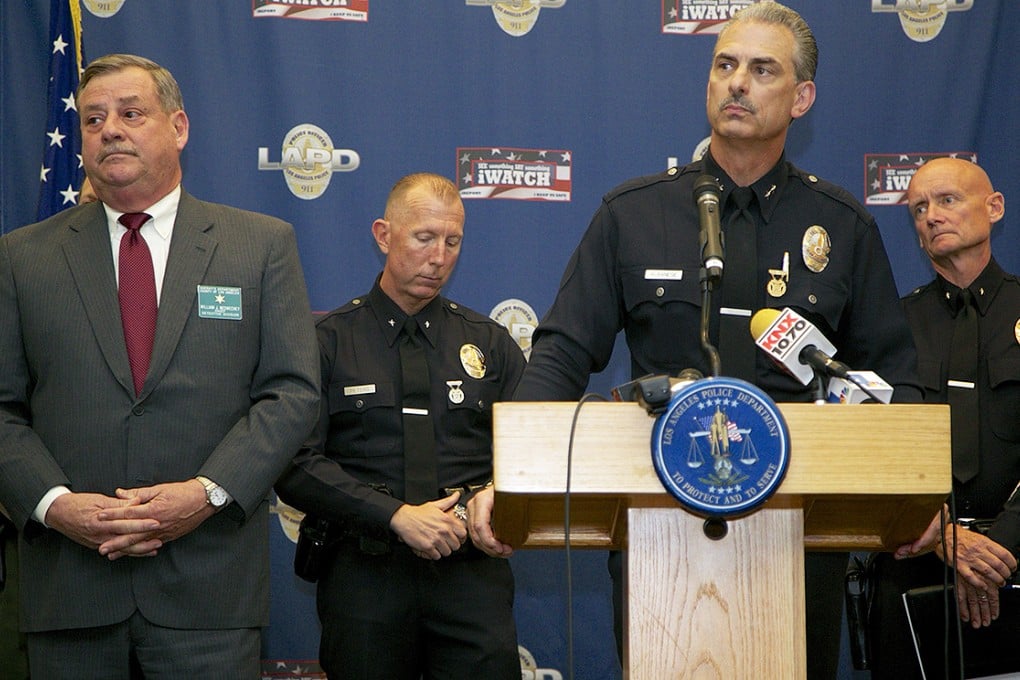 Los Angeles Police Department Deputy Chief Kirk Albanese, at podium, takes questions from the media about a serial killer now in custody who shot seven people, leaving four dead over five days. Photo: AP
