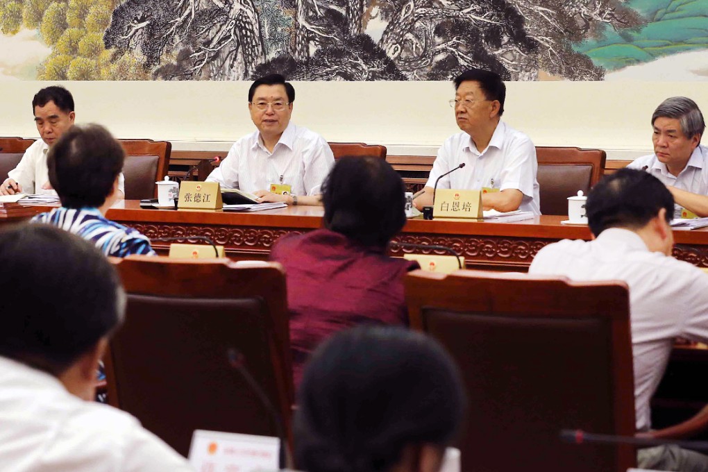 Zhang Dejiang (second left), chairman of the Standing Committee of China's National People's Congress (NPC), attends the 10th meeting of the 12th NPC Standing Committee in Beijing. <br> A draft resolution is expected to be table at the Standing Committee's plenary session this afternoon. Photo: Xinhua