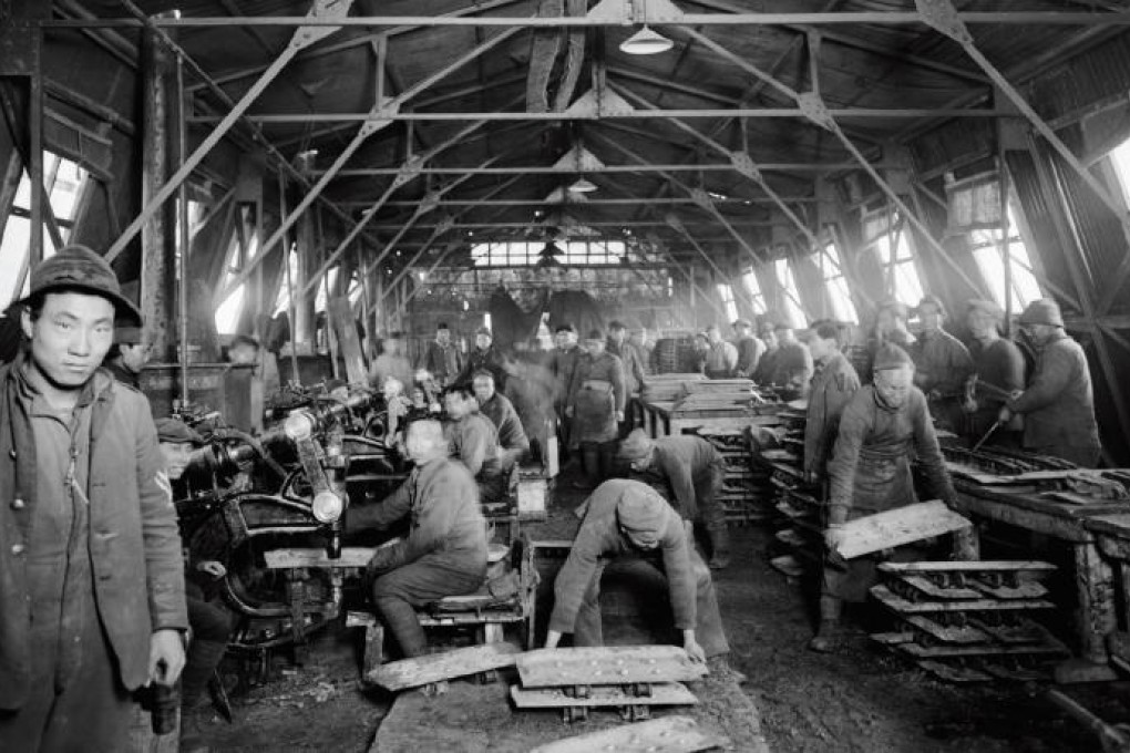 Members of the Chinese Labour Corps carryout riveting work at the Tank Corps Central Workshops, in France, during the first world war.