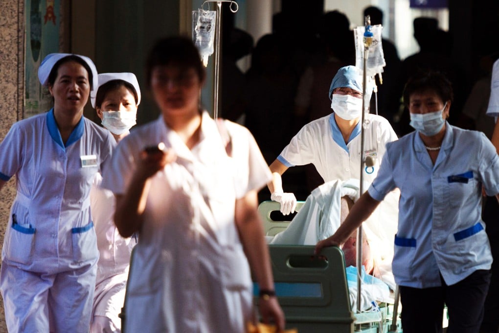 Doctors and nurses rush a victim of a factory explosion for treatment at a hospital in Kunshan. Photo: AFP