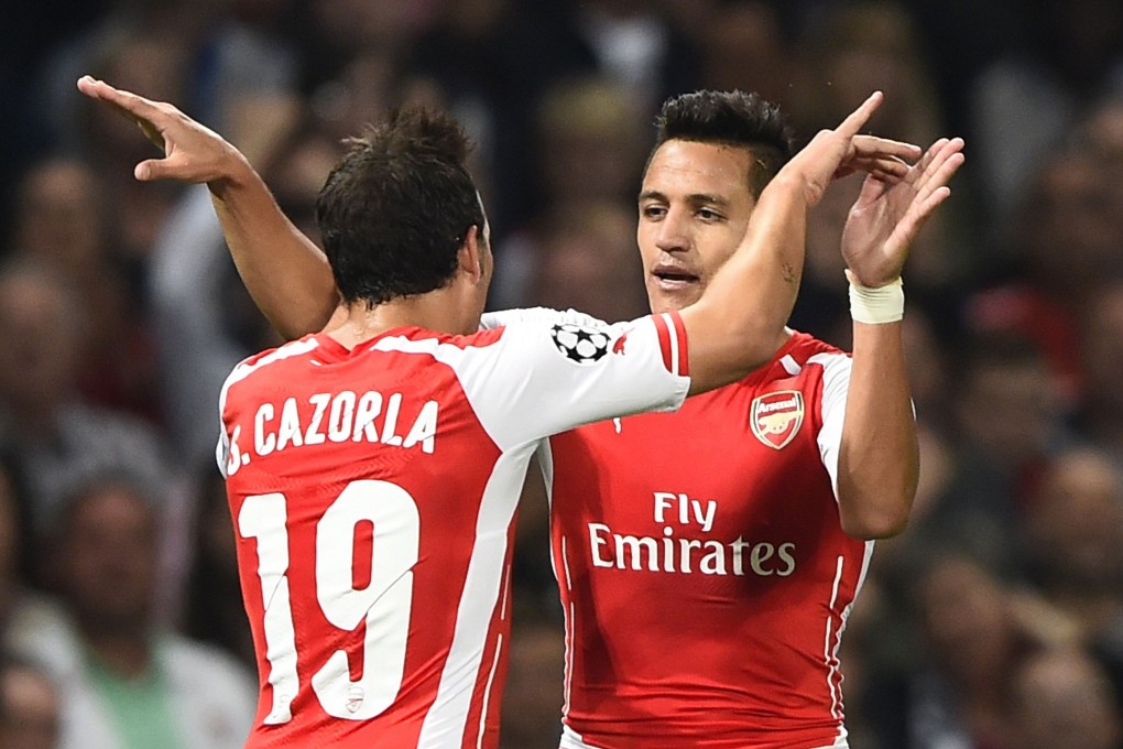 Alexis Sanchez celebrates with Santi Cazorla. Photo: Reuters