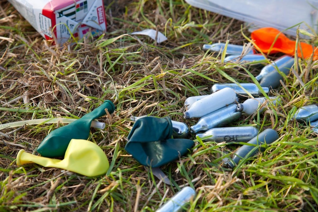 Discarded nitrous oxide canisters and balloons used for inhaling the gas litter the campsite at last year's Glastonbury Festival, in Britain. Photos: Corbis; Red Door News Hong Kong