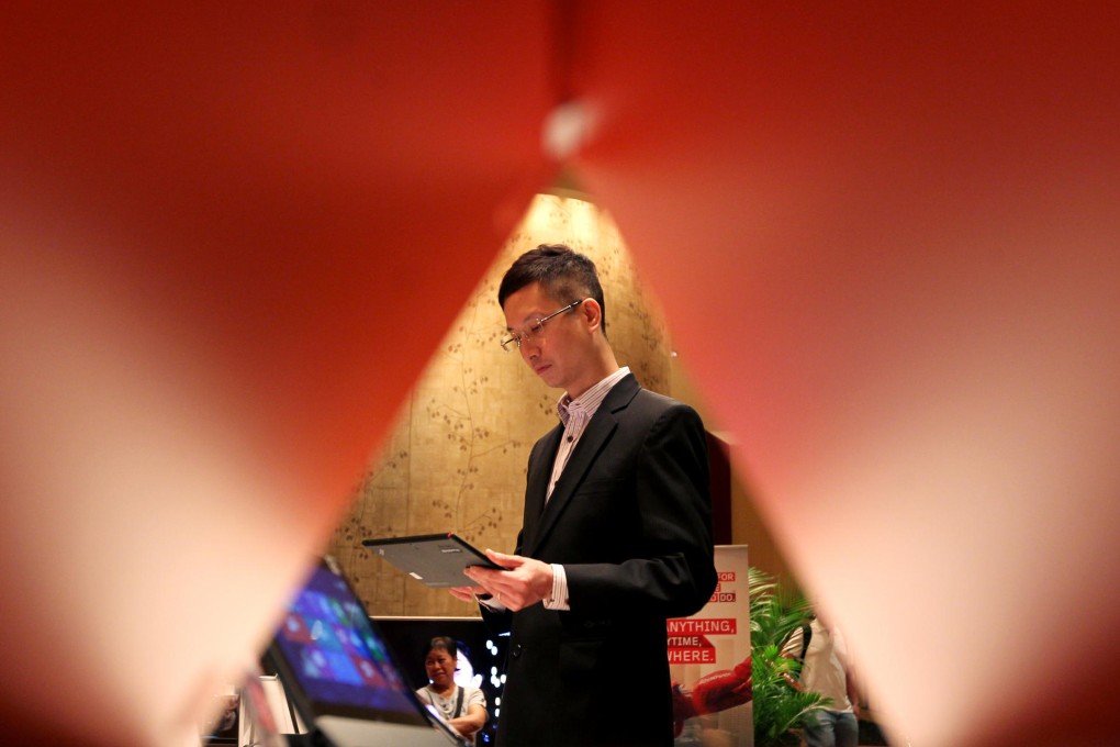 A customer checks out a product of Lenovo, which says it has zero tolerance for any child labour violations at its suppliers. Photo: Nora Tam