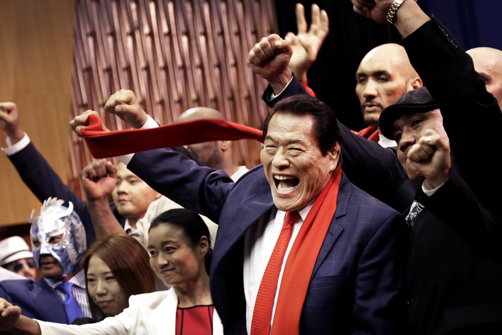 Japanese pro-wrestler-turned-politician Kanji "Antonio" Inoki, centre, poses with other pro-wrestlers during a press conference Thursday, August 28, 2014 in Pyongyang, North Korea. Photo: AP