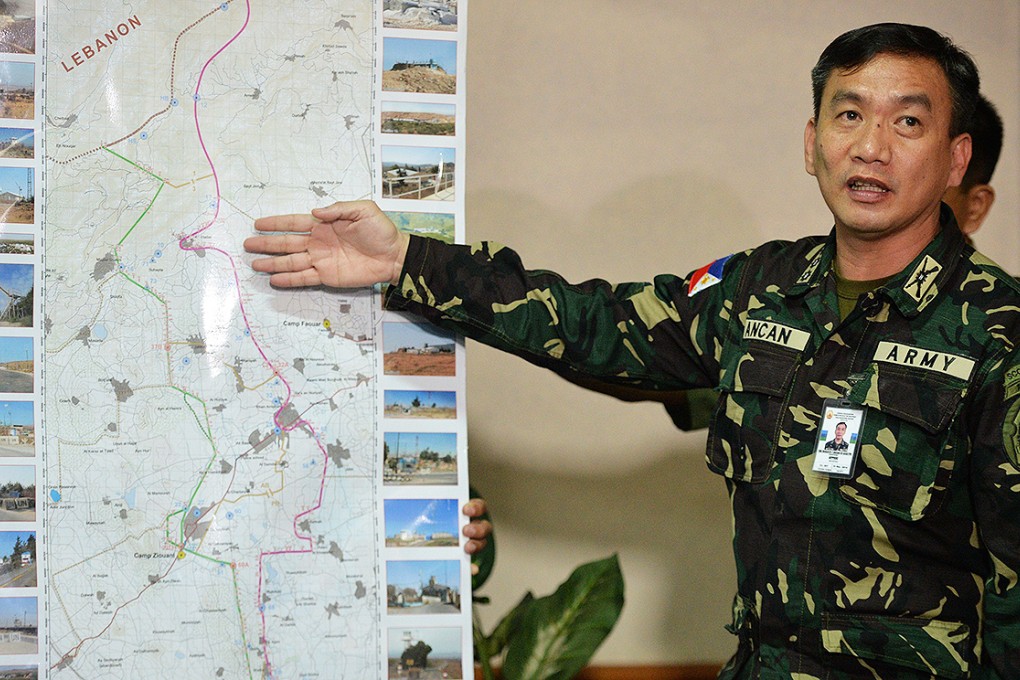 Colonel Roberto Ancan briefs the media in Manila on the situation in Syria. Photo: AFP