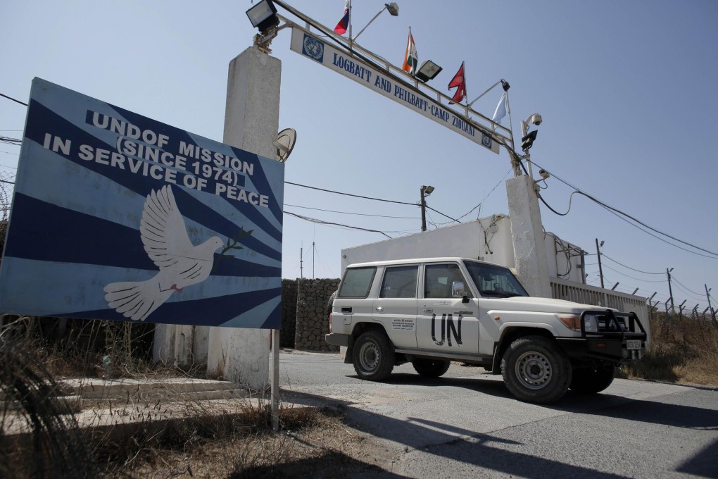 A UN vehicle leaves the UN base at the Quneitra crossing, the frontier between Syrian and Israeli controlled areas. Photo: AFP
