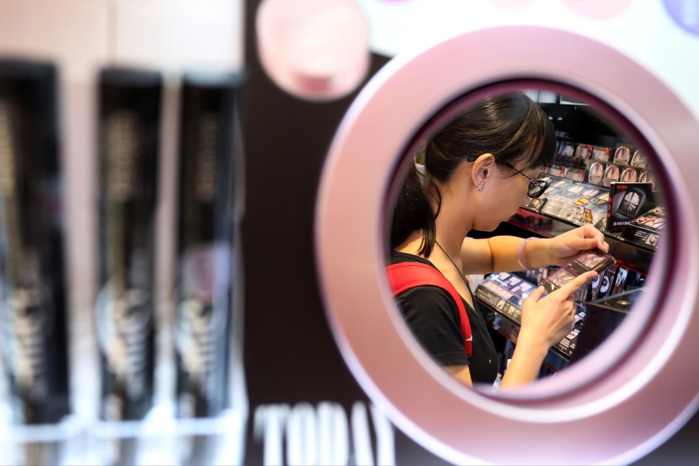 A young woman checks out some eye shadows at a Causeway Bay store yesterday, but packaging offers few clues as to whether a product was tested on animals. Photo: Nora Tam