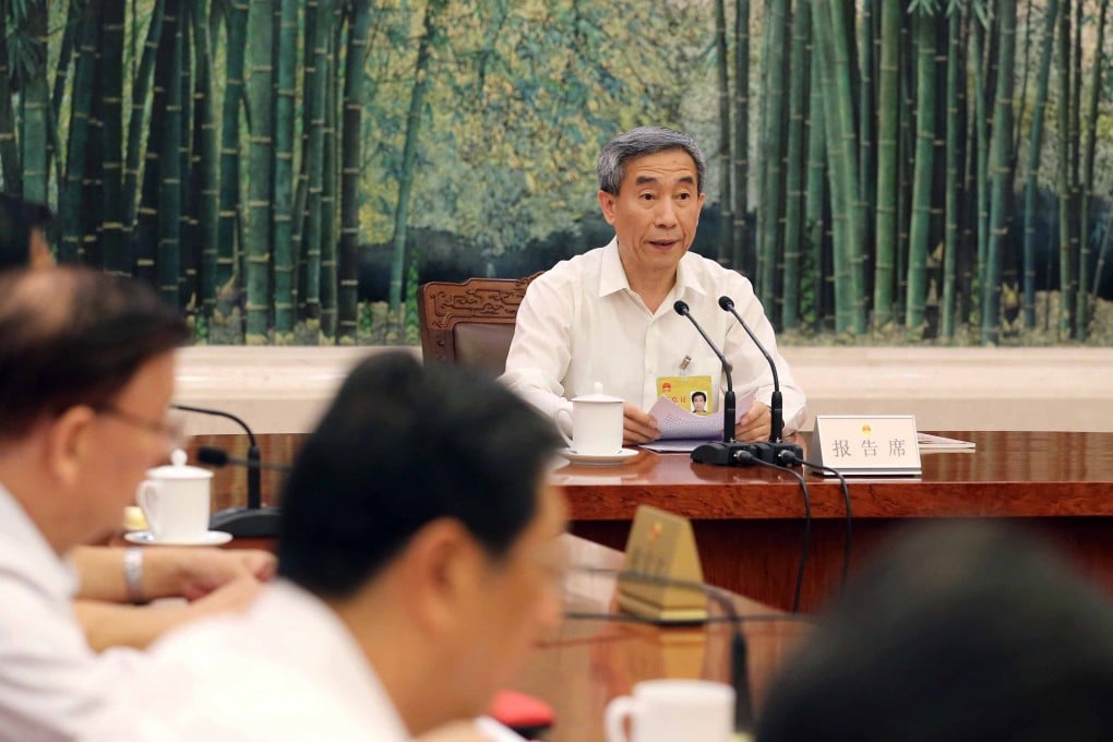 Li Fei, vice-general secretary of the National People's Congress (NPC) Standing Committee, gives a report on Hong Kong elections in Beijing on Aug. 27, 2014. Photo: Xinhua