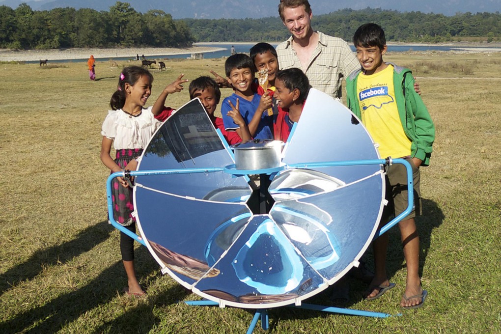 Scot Frank shows off the first version of his SolSource solar cooker in Nepal. Photo: One Earth Designs
