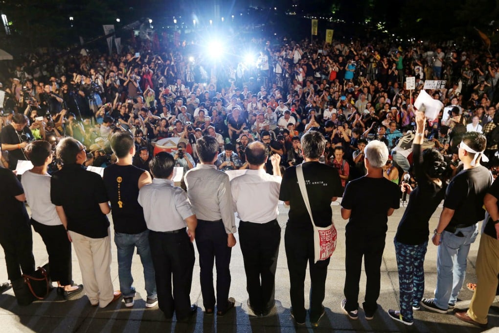 Occupy Central supporters rally outside government headquarters in Admiralty last night. They have vowed to push on with their campaign. Photo: Felix Wong