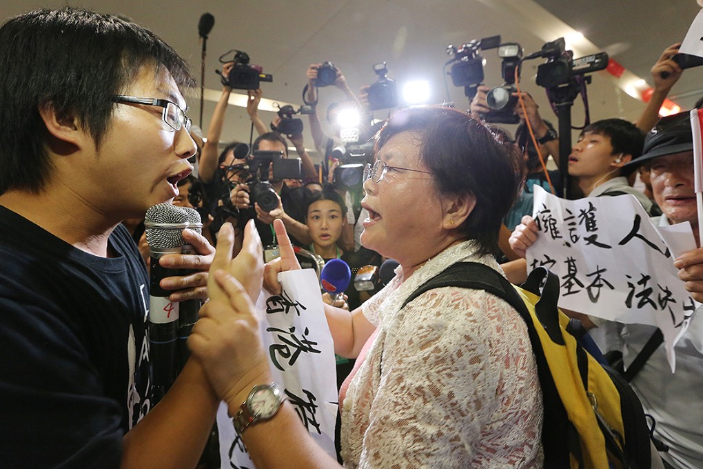 Protesters come face to face with Beijing loyalists and lines of police outside the conference hall yesterday. Photo: Felix Wong