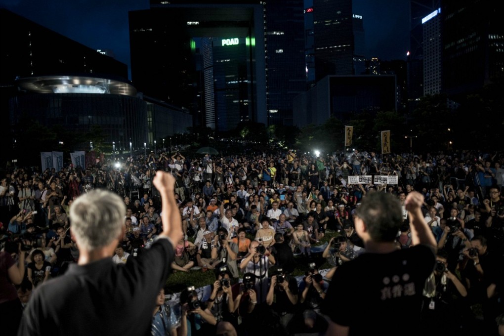 Leaders of the Occupy Central movement address a crowd gathered to protest Beijing's decision on the 2017 election on Sunday. Photo: AFP