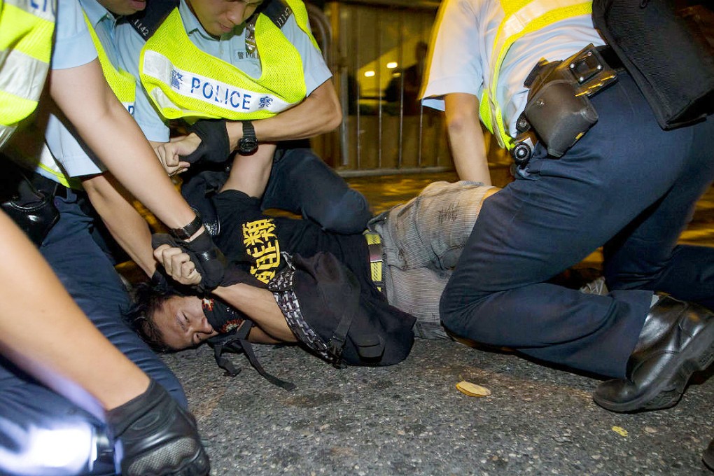 A pro-democracy activist is arrested outside the Grand Hyatt Hotel in Wan Chai. Photo: Reuters