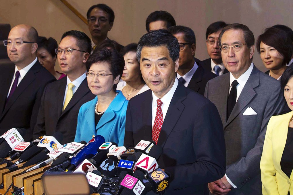 Hong Kong Chief Executive Leung Chun-ying (center) speaks with top officers during a news conference at the Chief Executive's Office. Photo: Reuters