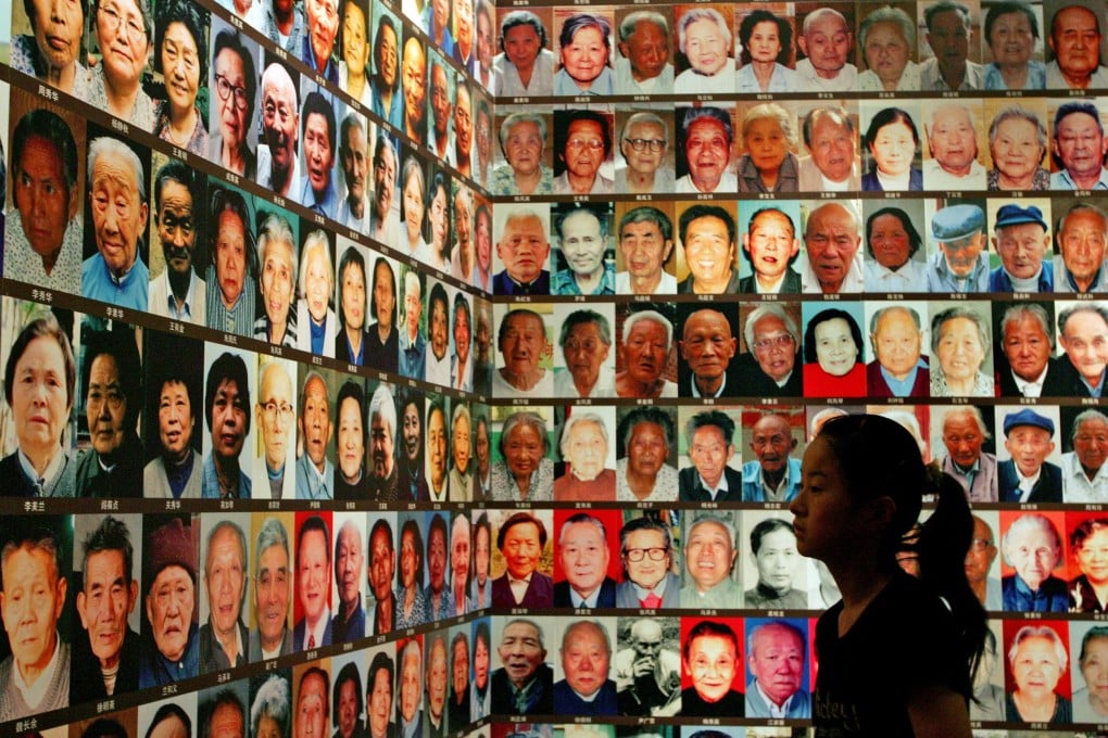 A Chinese girl looks at a wall of photographs of "Survivors of Nanking Massacre" at an exhibition at the National Museum in Beijing. Photo: Reuters
