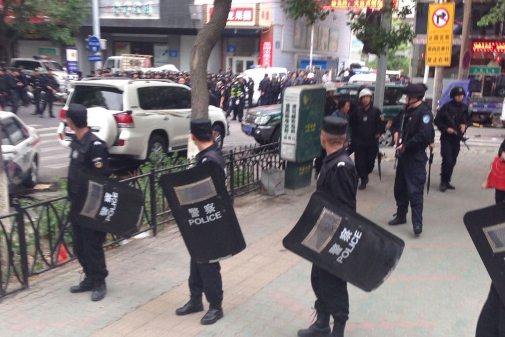 Police officers stand guard after an attack in Urumqi, the capital of Xinjiang Uygur autonomous region, in May. Toksun county and others are practicing how to respond to terrorist attacks. Photo: AP