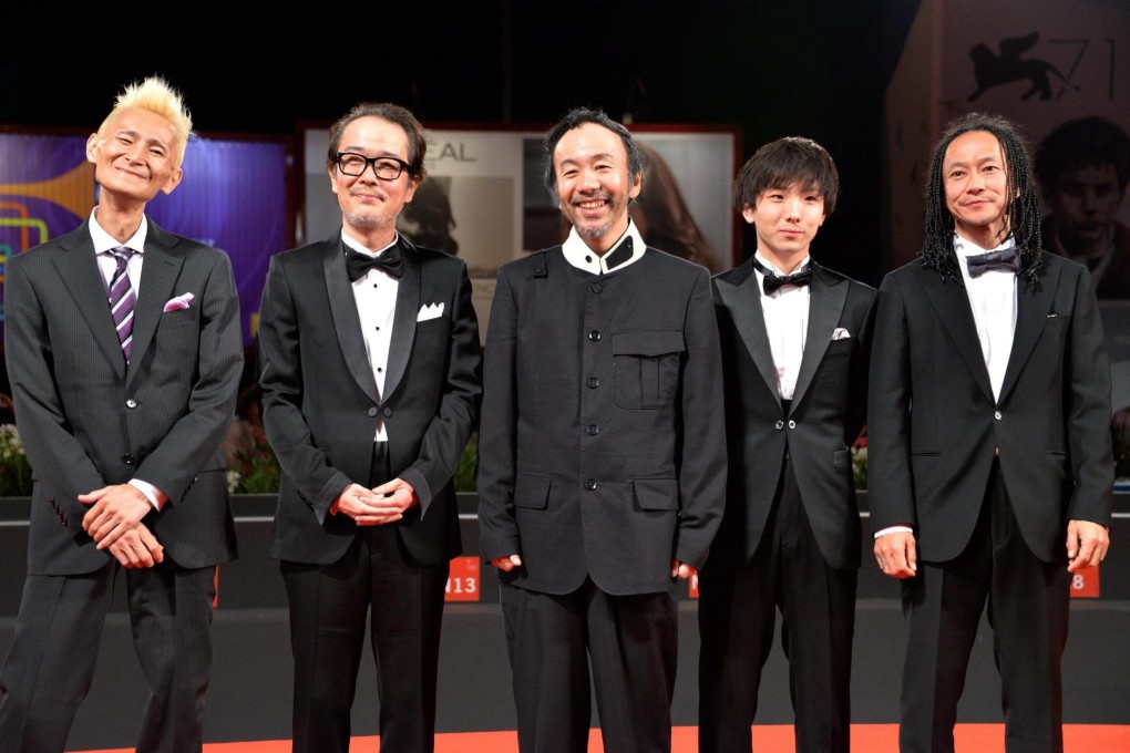 Composer Chu Ishikawa, cast member Lily Franky, director Shinya Tsukamoto, and cast members Yusako Mori and Tatsuya Nakamura at the Venice showing and a scene from the film. Photo: EPA