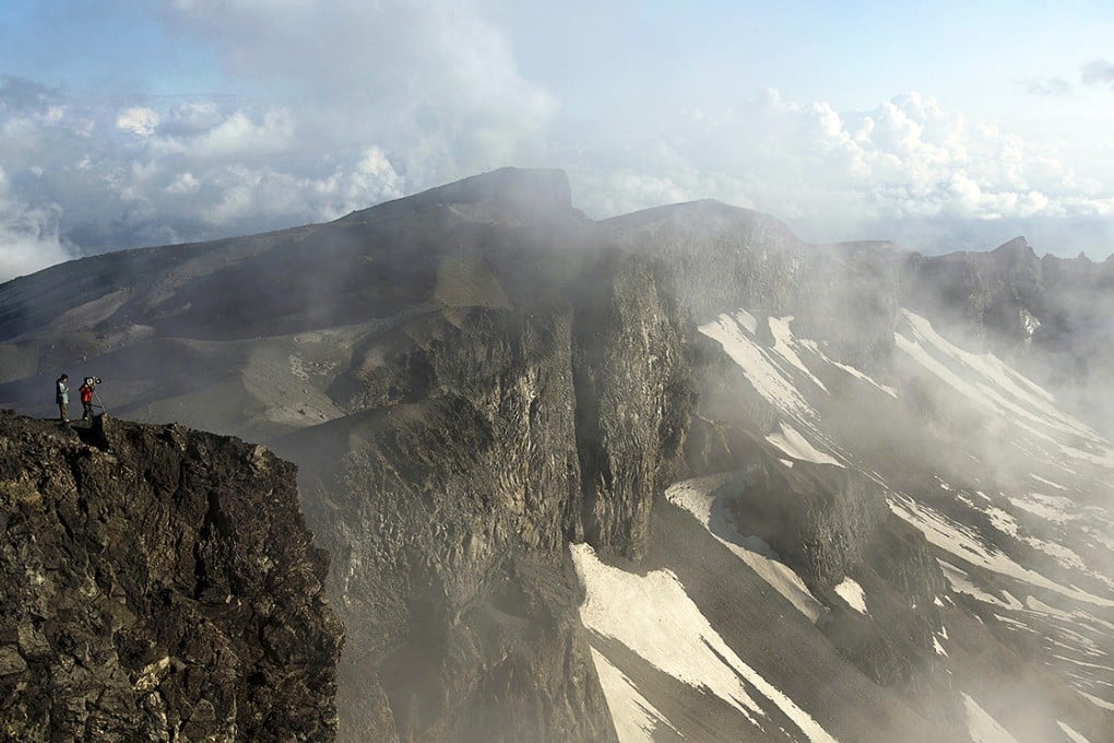 A North Korean television crew films Mount Paektu. Two British scientists are shedding light on the volcano's history and possible future thanks to an unprecedented joint project with Pyongyang. Photo: AP